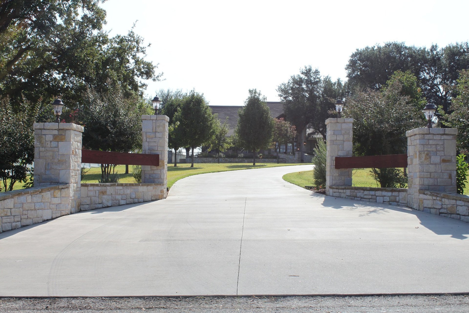 Elegant limestone gate entrance to a custom Tincher's estate home