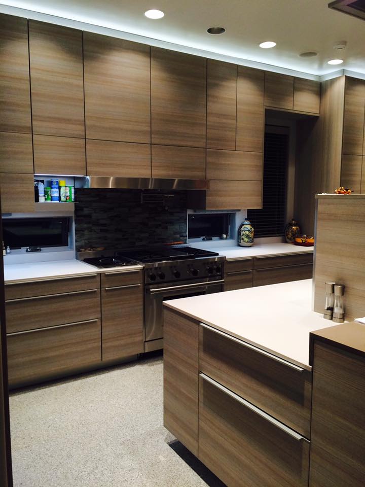 Modern custom kitchen remodel with walnut flat-panel cabinets, quartz countertops, and LED cove lighting — Tincher's Custom Homes