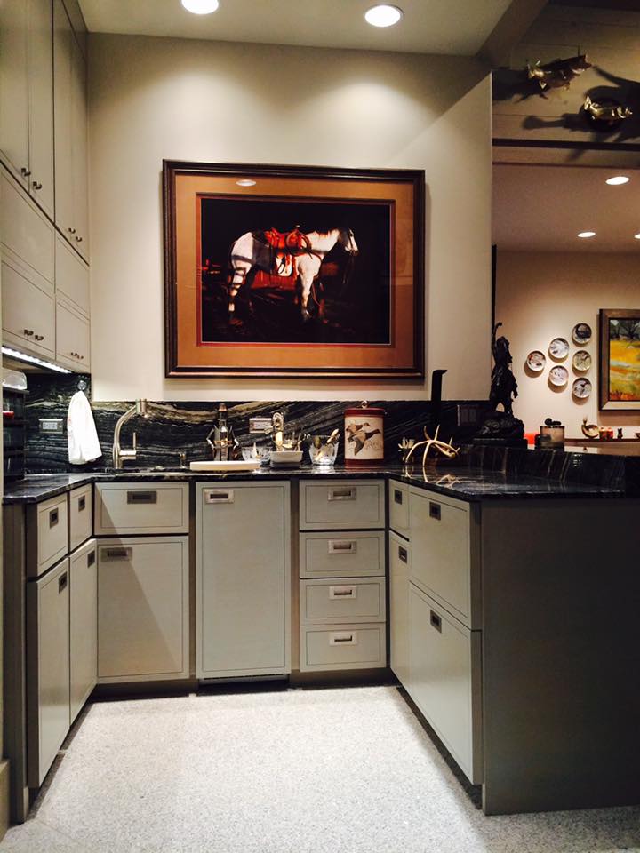 Kitchen remodel with gray shaker cabinets, black marble countertops, and framed Western art — Tincher's Custom Homes